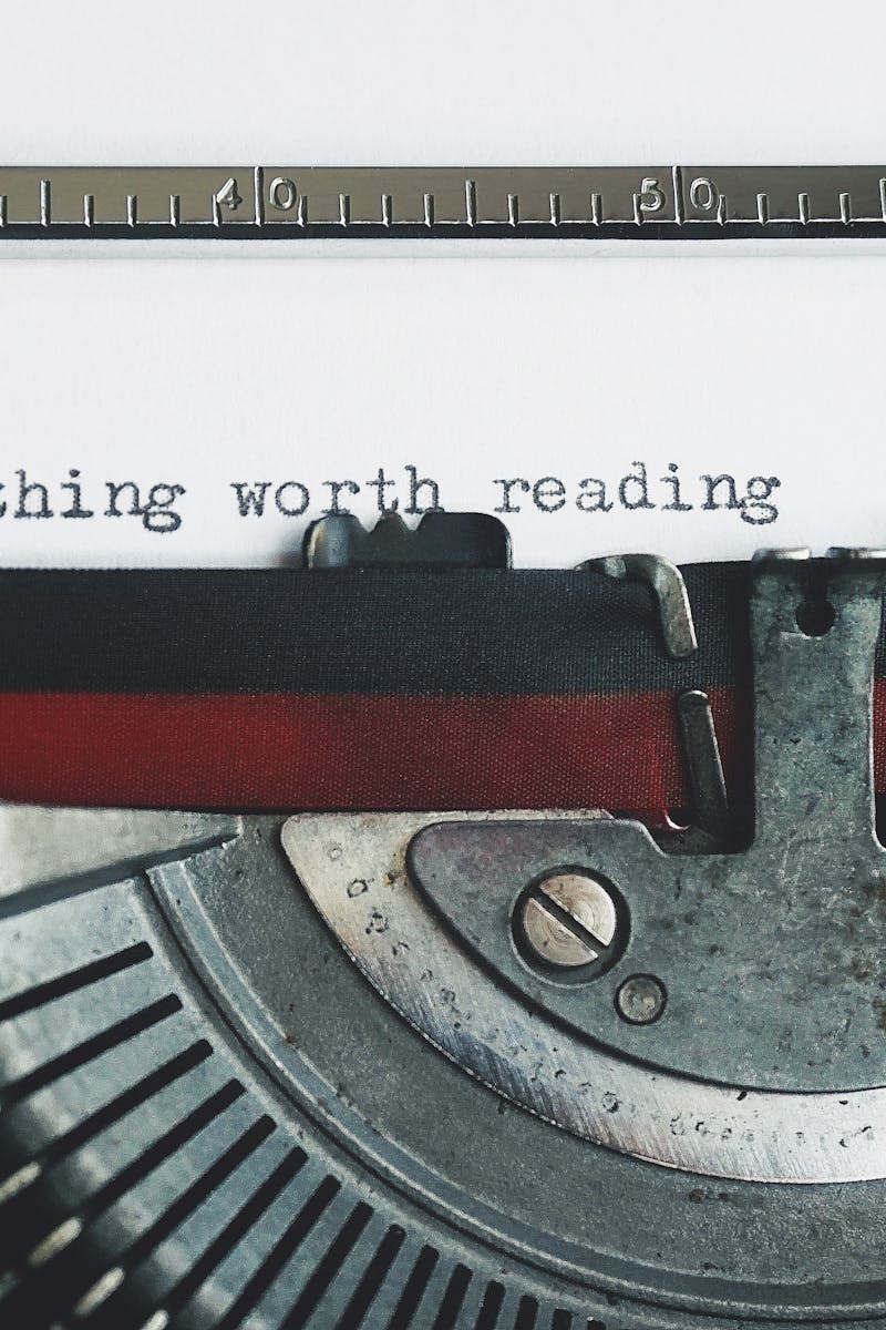 Black and Red Typewriter on White Table