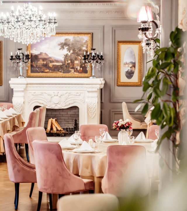 restaurant-hall-with-round-table-some-chairs-fireplace-plants